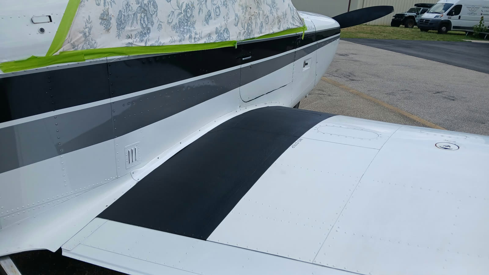Aircraft fuselage after Finish Pro spot repair. Clean stripes restored